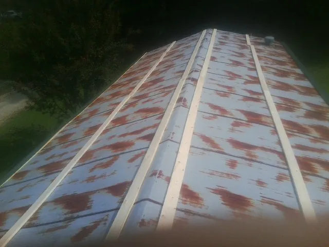 Rusted metal roof panels with new wood purlins before replacement — Storm Damage Roof Repair in Still Pond by Roofing Brothers