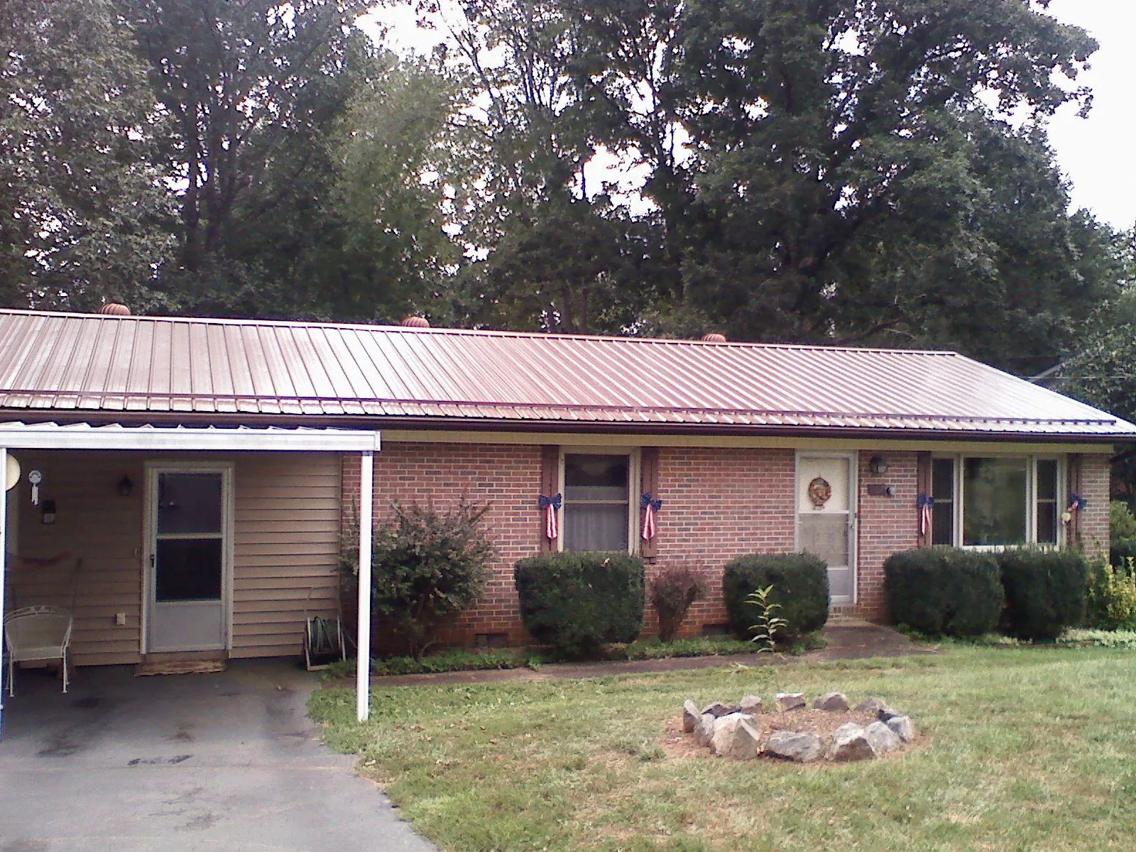 Bronze metal roof and carport on a brick ranch home — Roof Repair work by our crew in Still Pond